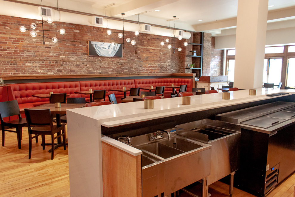 Images showcasing Kingdom Taproom & Table’s cozy dining environment with custom booths, tabletop settings, and commercial bar equipment.
