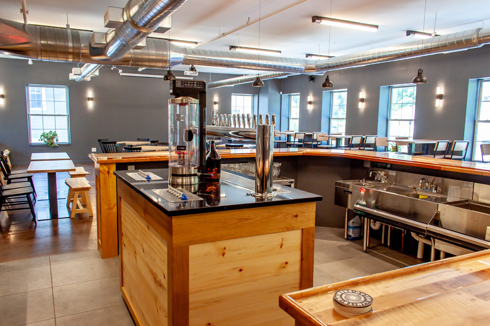 Photos highlighting the brewery’s architecture, equipment, bar area, and warm, rustic dining environment.