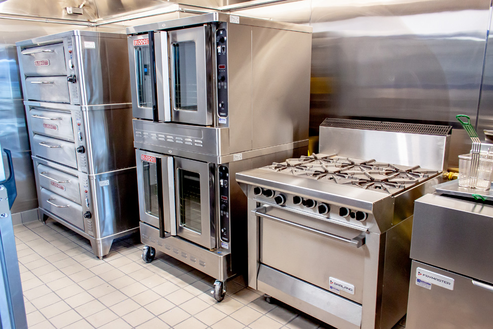 Modern kitchen with stainless steel commercial cooking equipment